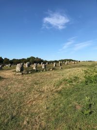 Hay bales on field against sky