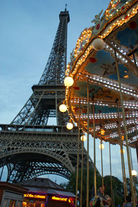 Low angle view of illuminated ferris wheel against sky