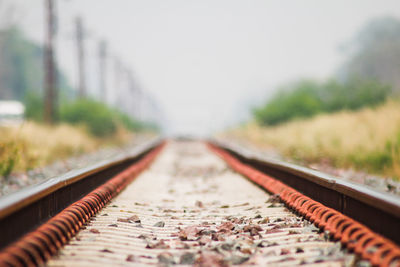 Surface level of railroad tracks against sky