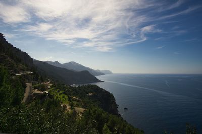 Scenic view of sea and mountains against sky