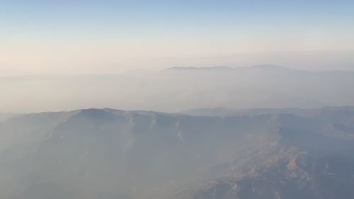 Aerial view of mountains against sky during summer