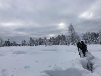 Snow covered field against sky