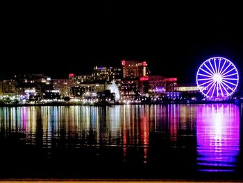 Illuminated ferris wheel at night