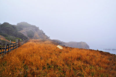 Scenic view of field and mountains against sky