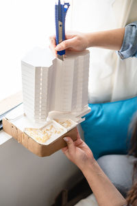 Woman making paper model at home