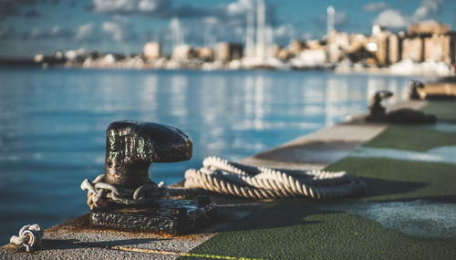 Close-up of ropes on pier at harbor