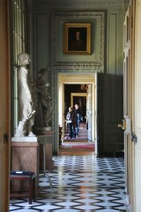 Statue of people in corridor of historic building