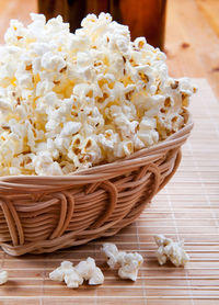 Close-up of popcorn in wicker basket on table