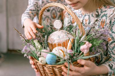 Happy easter holiday time spring season. family little kids holds basket painted eggs baked cakes