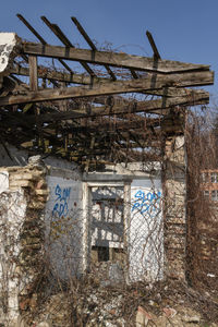 Low angle view of old abandoned building against sky