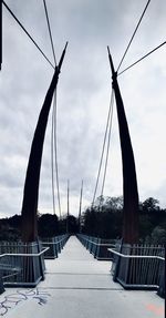 Low angle view of footbridge against sky