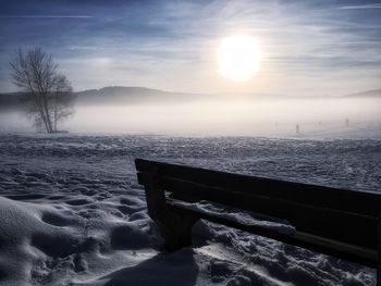 Scenic view of snowcapped mountains against sky during sunset