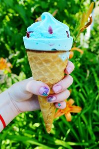 Hand holding ice cream cone