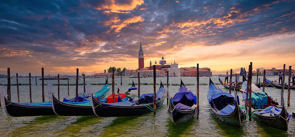 Boats in grand canal against sky during sunset