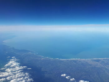 Aerial view of sea against blue sky