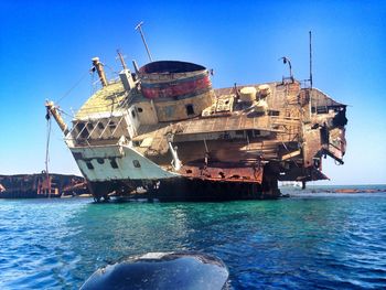 Shipwreck at tiran island against sky on sunny day