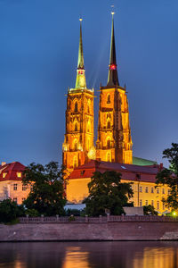 Illuminated building against sky at dusk