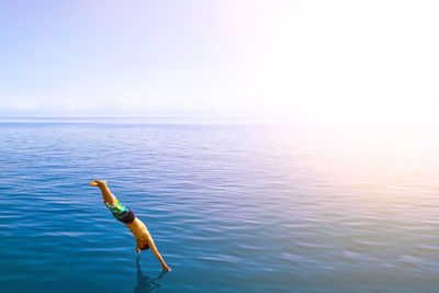 Full length of man jumping in sea