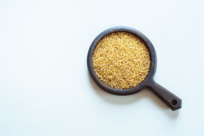 Directly above shot of bread in bowl against white background