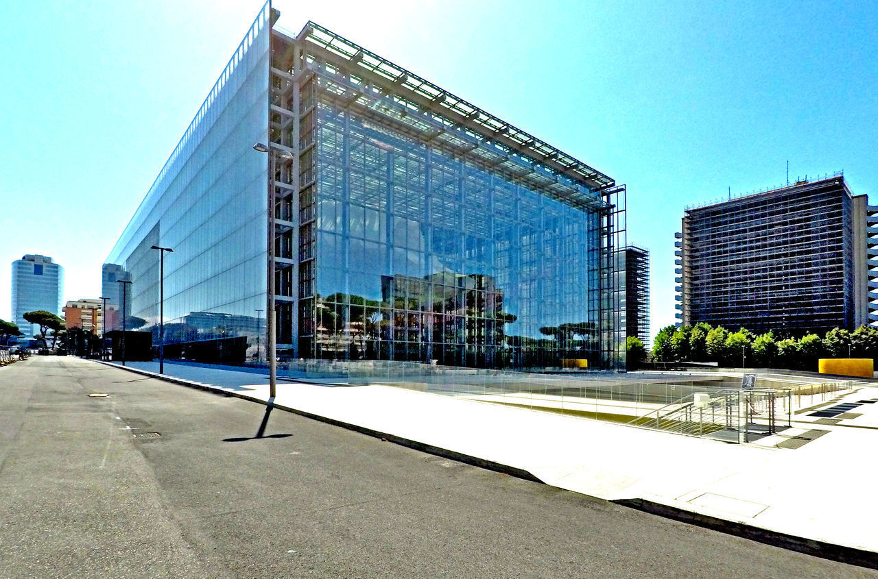 MODERN GLASS BUILDING AGAINST SKY