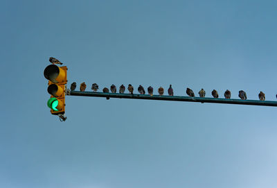 Low angle view of street light against clear blue sky