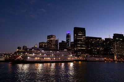 Illuminated city at waterfront