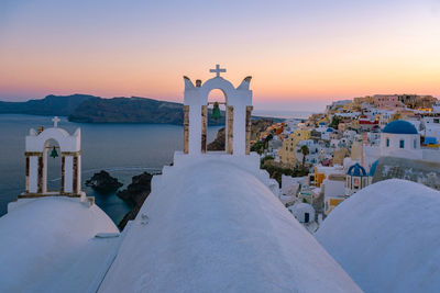 Panoramic view of beach and buildings against sky during sunset