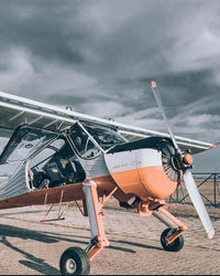 View of airplane against cloudy sky