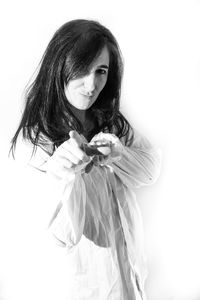 Portrait of woman standing against white background