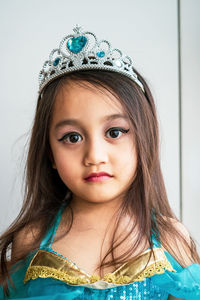 Portrait of cute girl wearing tiara and princess costume