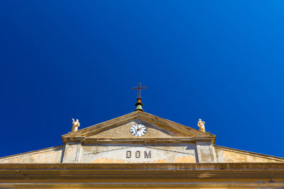 Low angle view of building against clear blue sky