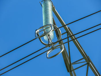 Low angle view of electricity pylon against clear sky