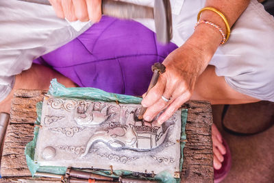 Close-up of person hands crafting sculpture at workshop