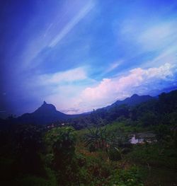Scenic view of landscape and mountains against sky