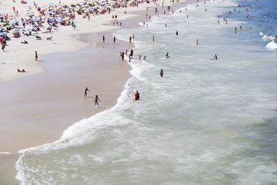 High angle view of people enjoying at beach