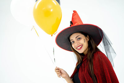 Portrait of a smiling young woman holding balloons