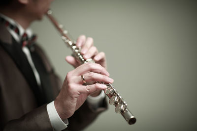 Midsection of man playing guitar