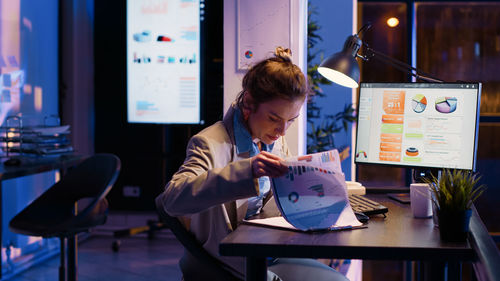 Young woman using laptop at cafe