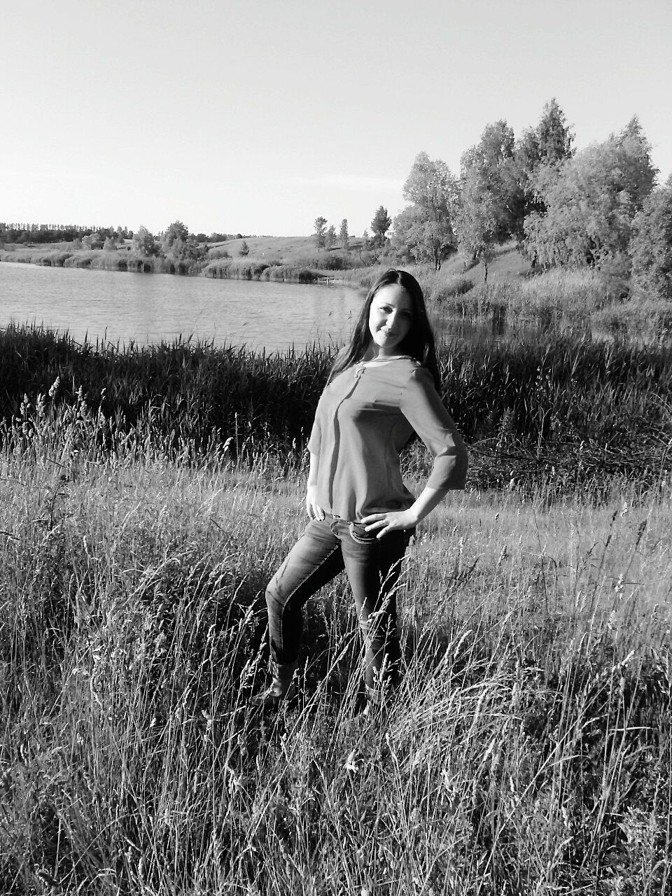 grass, field, young adult, lifestyles, full length, person, casual clothing, leisure activity, grassy, young women, landscape, three quarter length, nature, standing, clear sky, plant, tranquility, tree