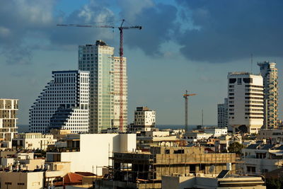 Modern buildings in city against sky