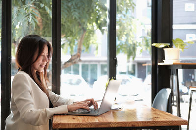 Young woman using laptop at home