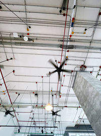 Low angle view of illuminated lights hanging from ceiling in building