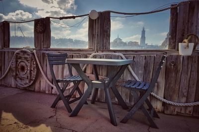 Abandoned chair against sky