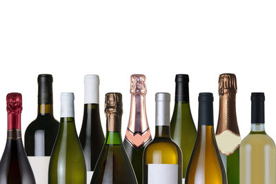 Close-up of glass bottles against white background