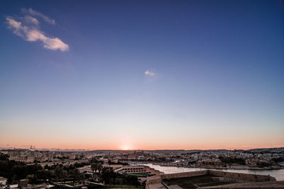 High angle view of buildings against sky at sunset