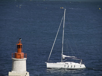 Sailboat sailing on sea against sky