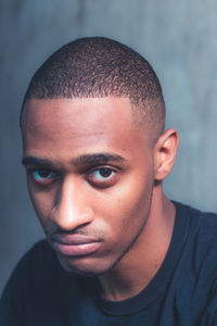 Close-up portrait of young man staring. focused