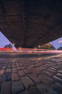 Illuminated bridge against sky at night