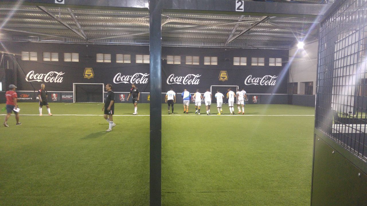 GROUP OF PEOPLE IN FRONT OF AN EMPTY STADIUM