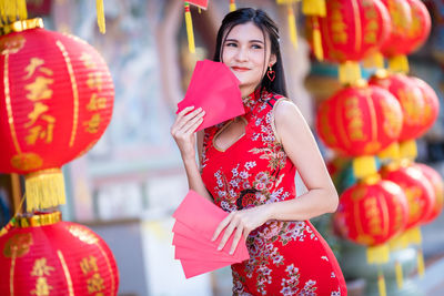 Woman standing with red lanterns